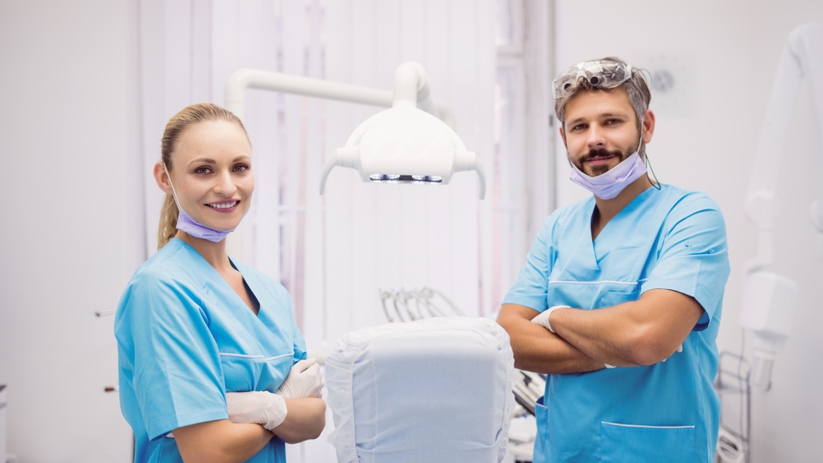 Portrait of dentist standing with arms crossed at dental clinic