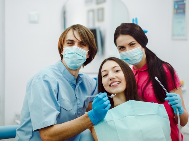 Assistant dentist and the patient in the clinic.